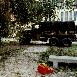 National Guard truck parked in walkway surrounded by debris