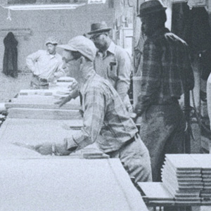 black and white photo of workmen in factory