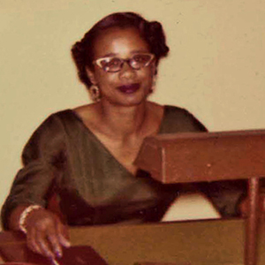 Dr. Catherine McCottry seated at desk.